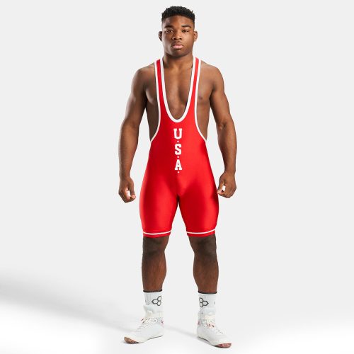 A male wrestler in a vibrant red singlet featuring USA printed on the front showcasing athleticism and readiness for competition