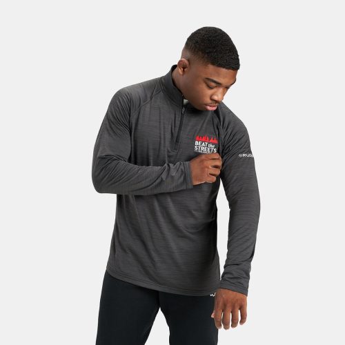 A young man is wearing a stylish fitted gray athletic pullover featuring the logo BEAT the STREETS in red demonstrating an activewear aesthetic