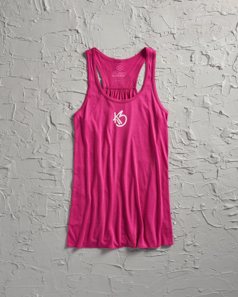 A vibrant pink tank top with a sporty design featuring a stylized logo at the front set against a textured gray background