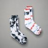 A pair of colorful tie-dye socks featuring black and white patterns alongside a red white and blue design both with a distinctive logo