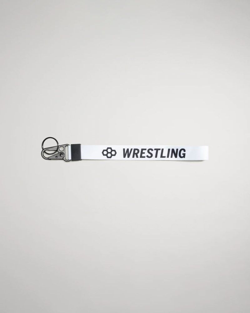 A white fabric strap labeled WRESTLING with a clip designed for holding keys or other small items