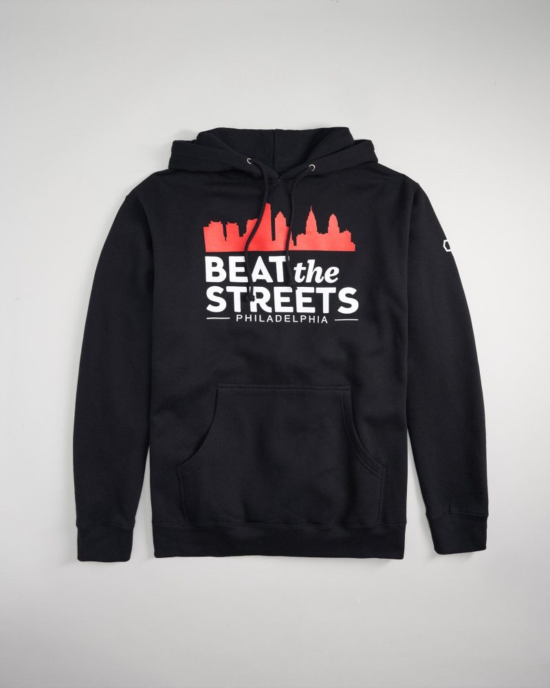 A black hoodie featuring a graphic design with the phrase BEAT the STREETS PHILADELPHIA and a skyline silhouette in red