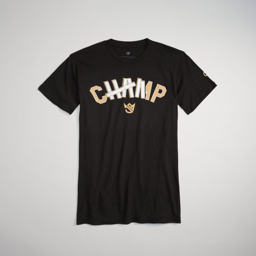 A black t-shirt featuring a partially crossed-out CHAMP text in bold golden letters highlighting a playful twist on the classic champion motif