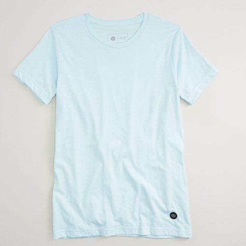 A light blue short-sleeved t-shirt displayed against a neutral background featuring a simple crew neckline and a subtle logo on the bottom left side