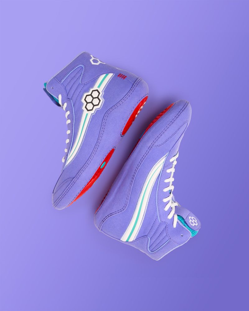 Purple high-top sneakers featuring white and green stripe accents red soles and a unique hexagonal logo on the outer side