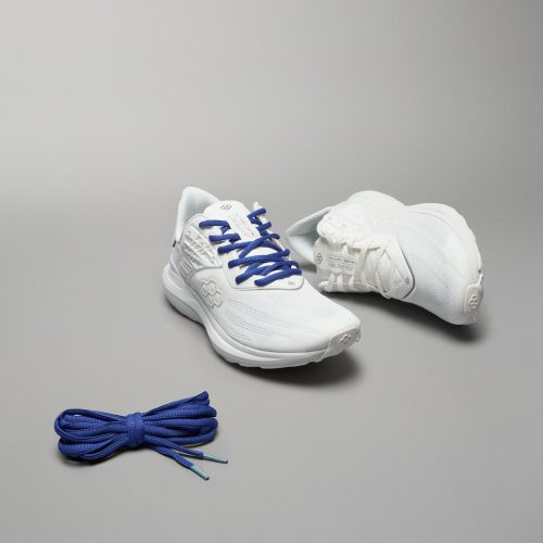 A pair of modern white athletic shoes with blue laces accompanied by a matching set of blue shoelaces displayed against a neutral gray background