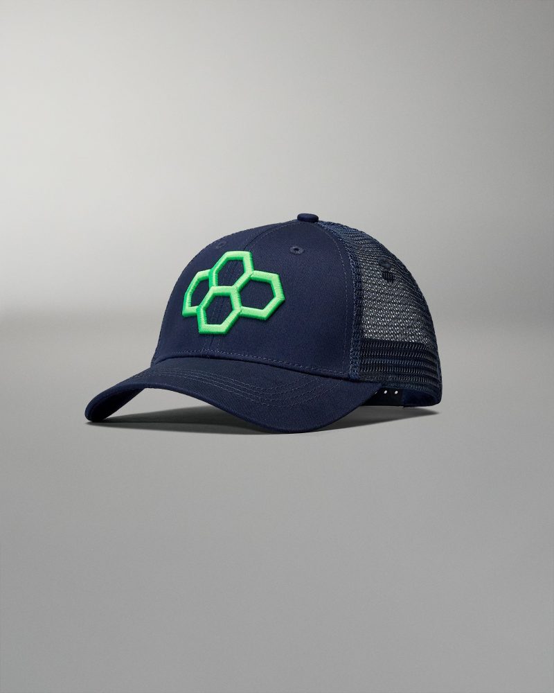 A navy cap with a green hexagonal logo and breathable mesh back, designed for style and comfort in casual wear.