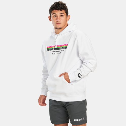 A young man poses in a stylish white hoodie featuring a colorful Sports Illustrated print complemented by gray shorts with WRESTLING text